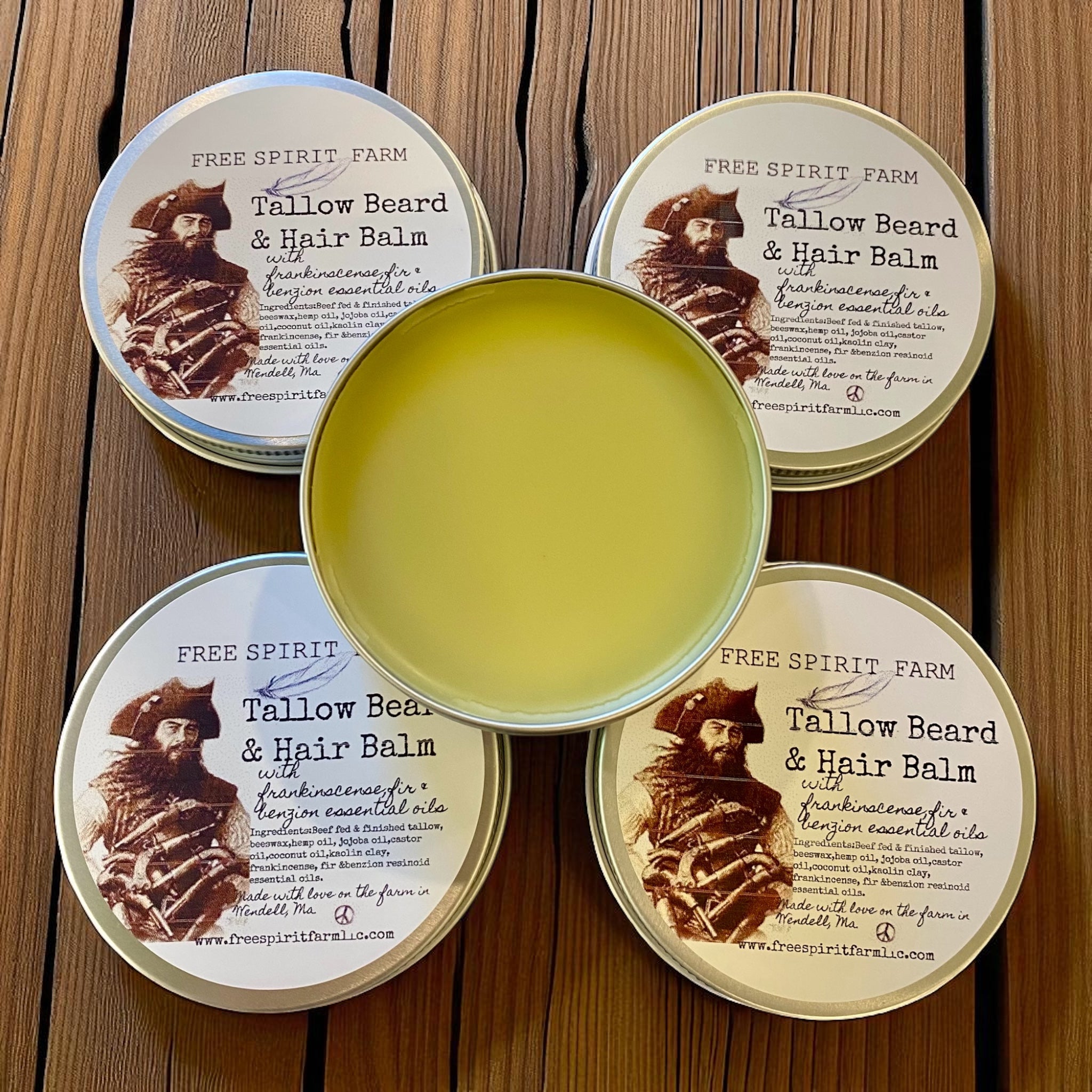 Tallow Beard & Hair Balm container with open lid on a wooden surface