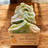 A bar of handmade goat milk soap labeled &