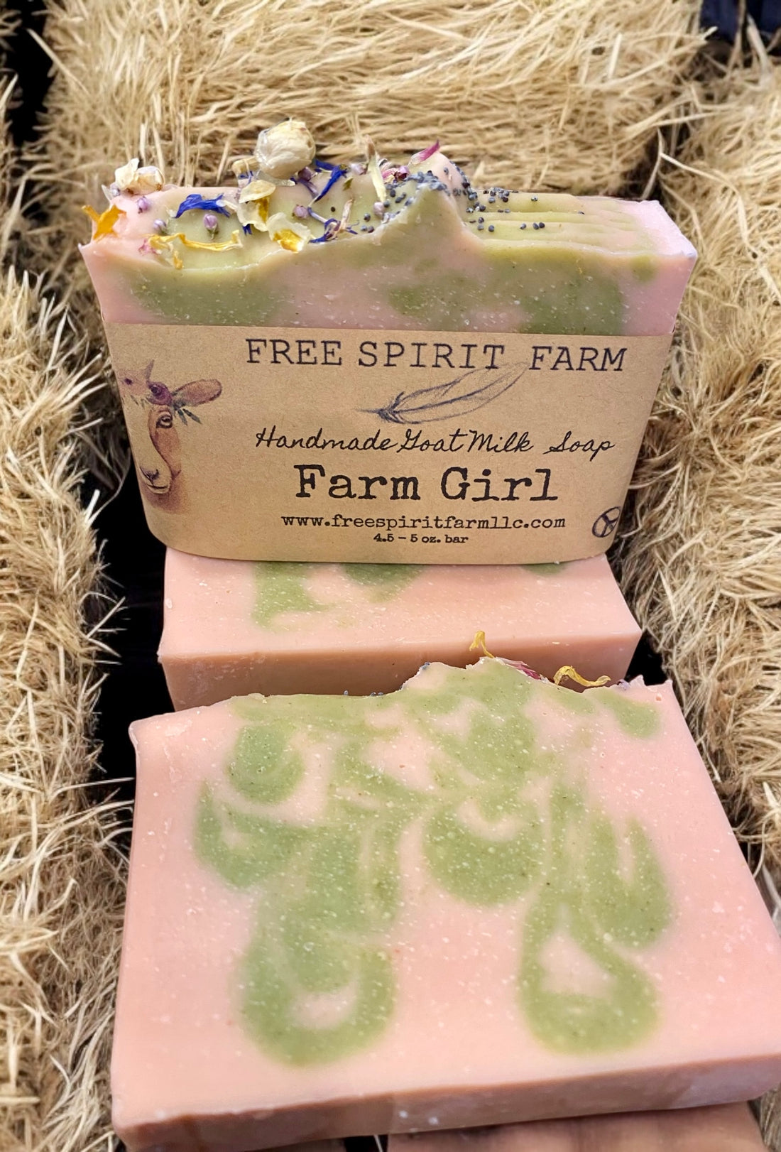 Goat milk soap bars with floral design on top, labeled &