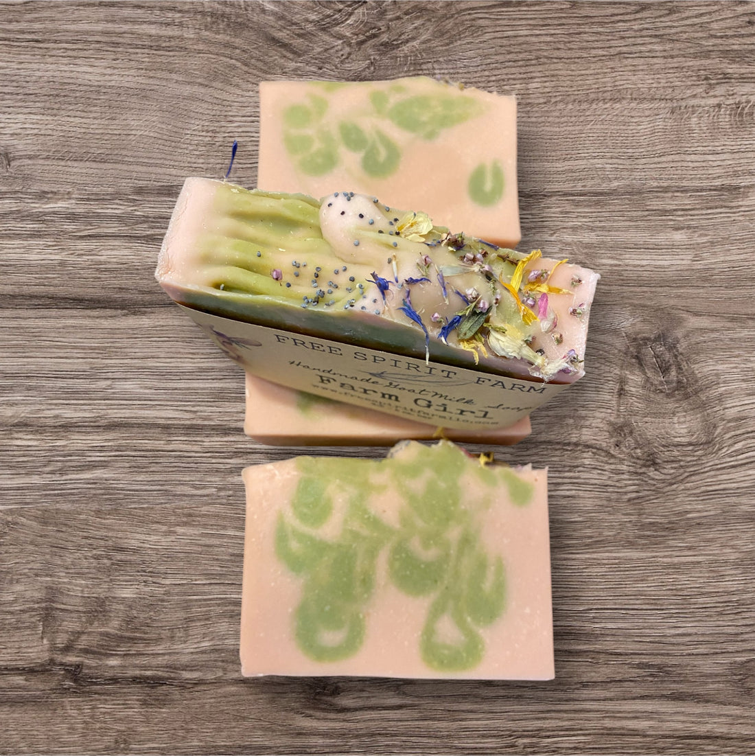 Goat milk soap bars with floral design on top, labeled &