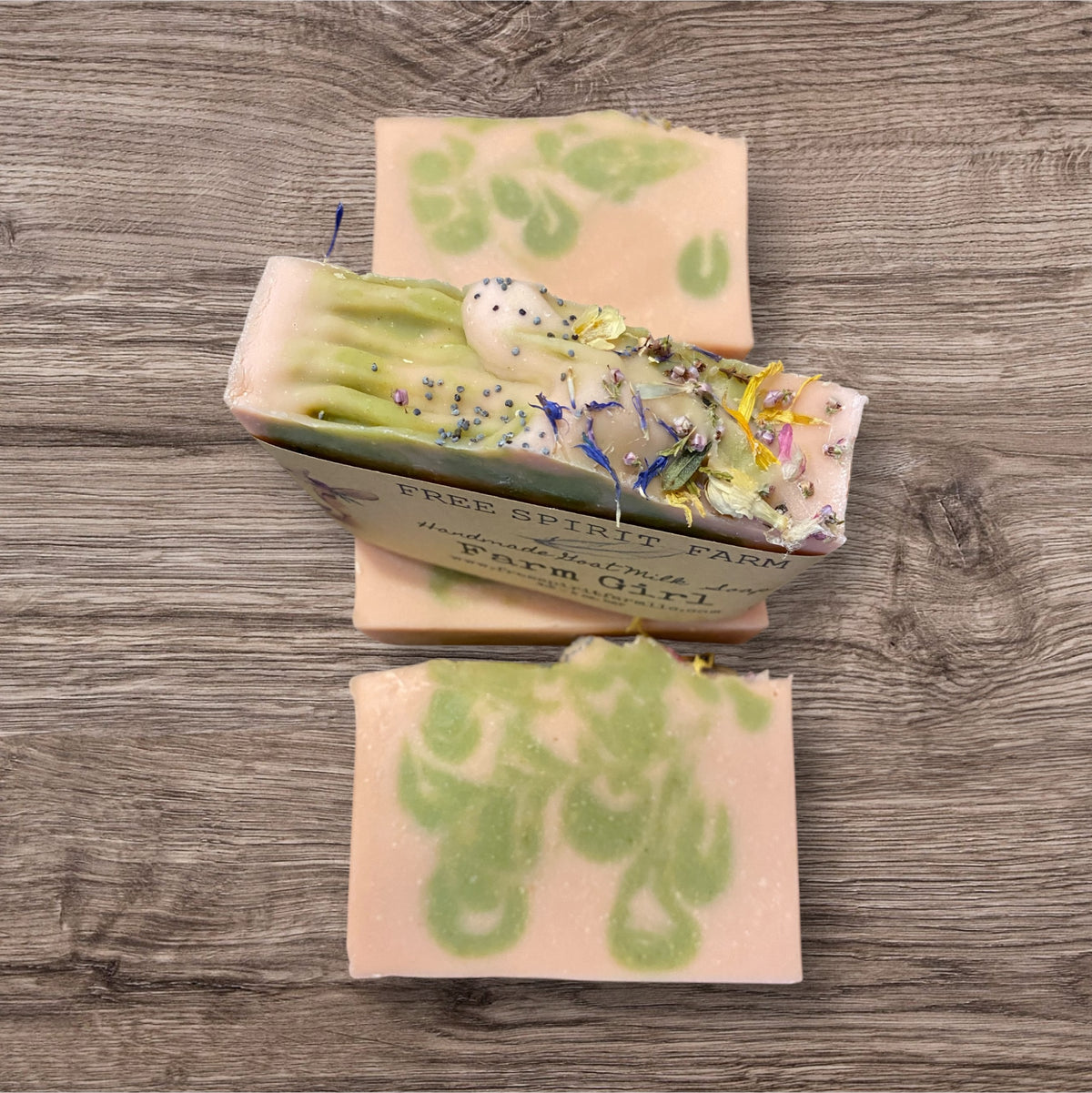 Goat milk soap bars with floral design on top, labeled &