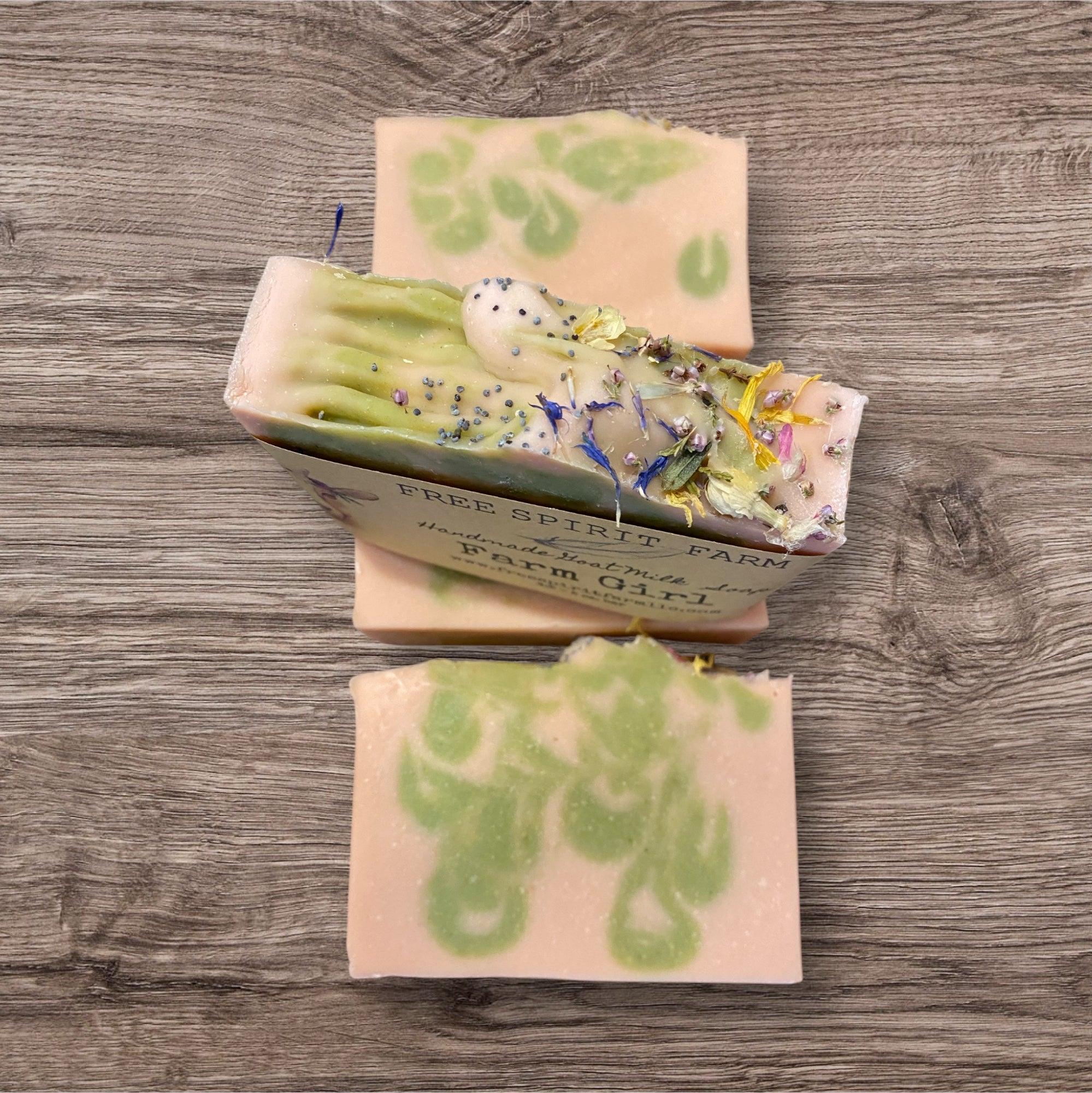 Goat milk soap bars with floral design on top, labeled &