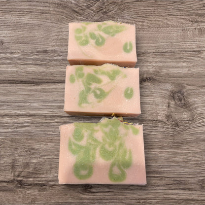 Goat milk soap bars with floral design on top, labeled &
