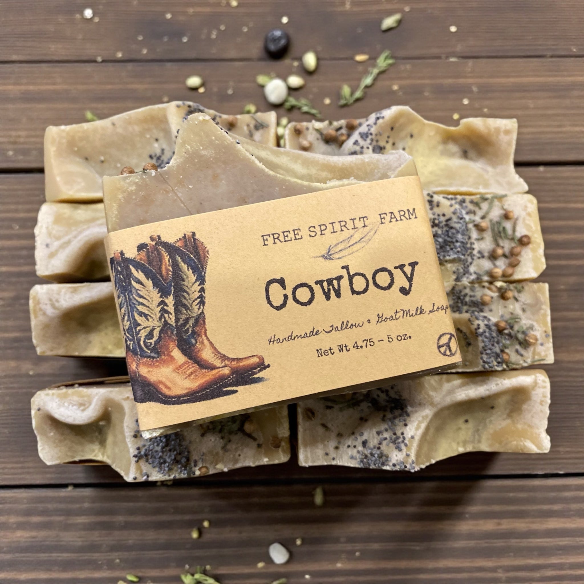Stack of cowboy-themed soap bars with a label on a wooden surface