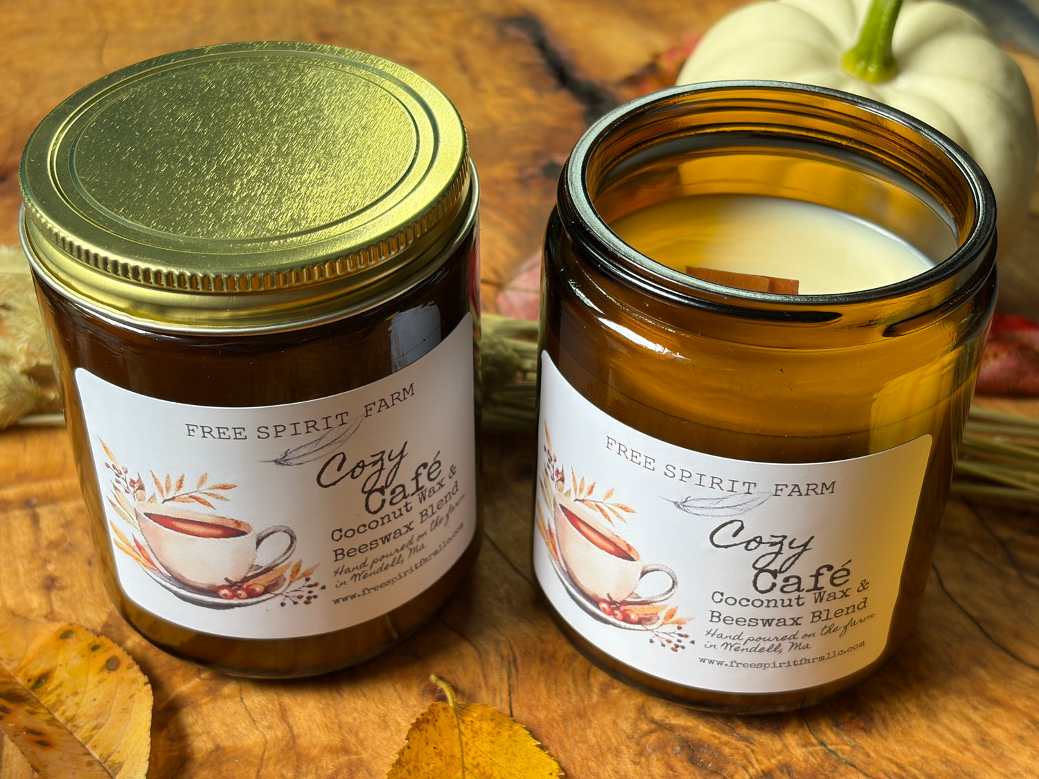 Two amber glass jar candles from Free Spirit Farm, labeled &