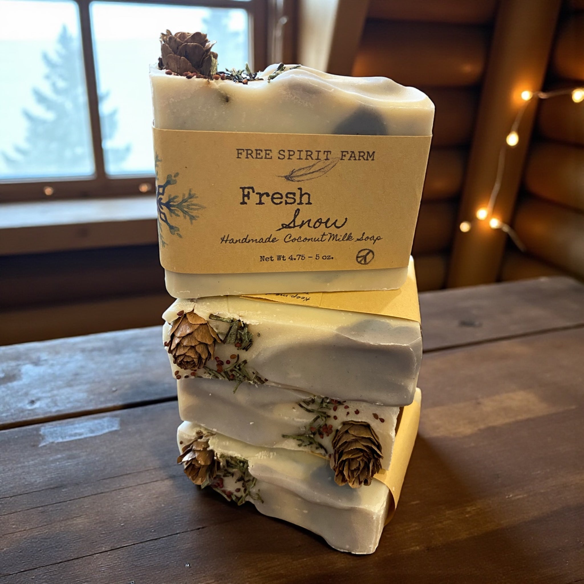Stack of handmade soap bars with a &