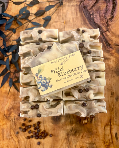 A top-down view of a bar of handmade soap labeled &