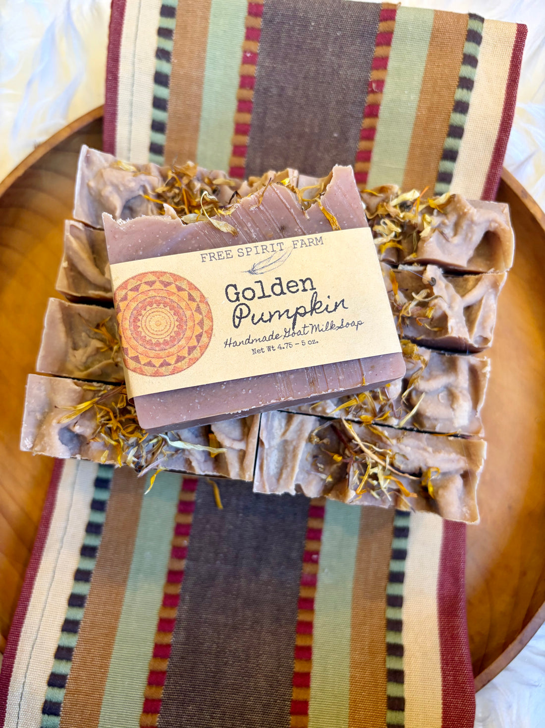 A bundle of handmade soap bars labeled &