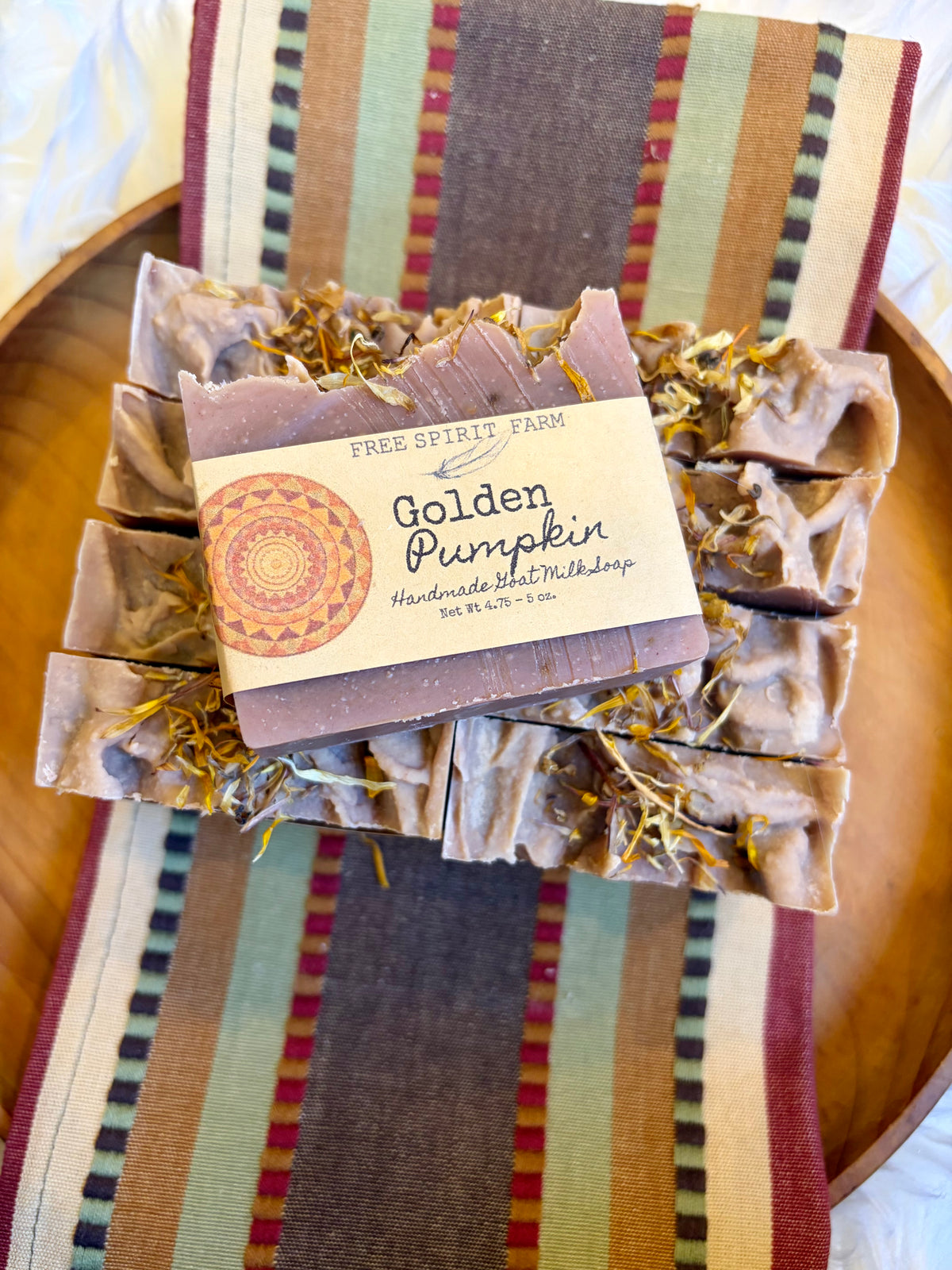 A bundle of handmade soap bars labeled &
