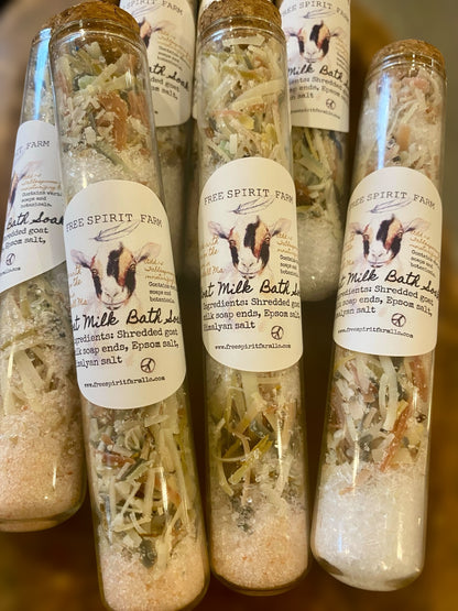 Bottles of Free Spirit Farm milk bath salts on a wooden surface