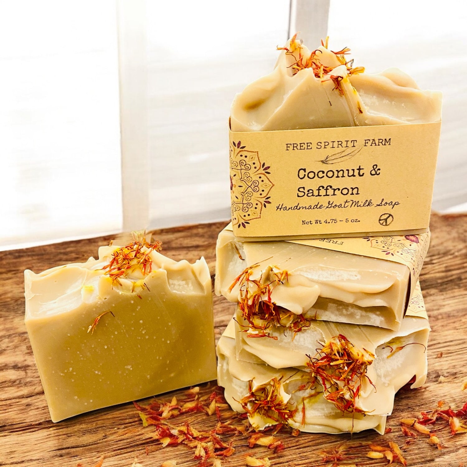 Coconut and saffron soap with packaging on a wooden surface