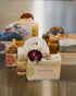 Collection of handmade soaps with decorative elements on a metallic surface
