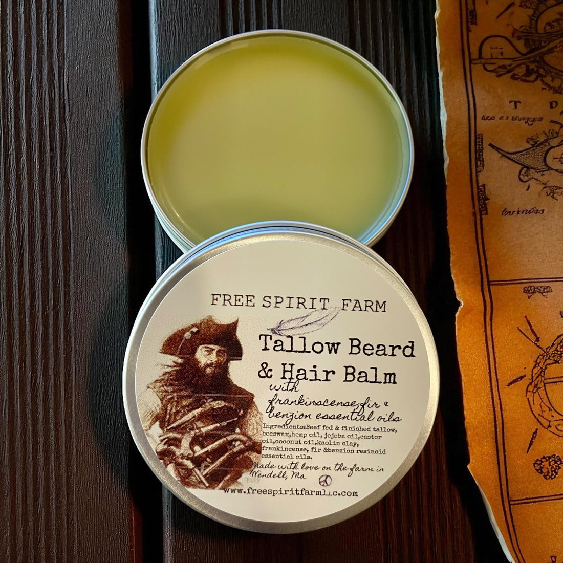 Tallow beard and hair balm container with label on a wooden surface