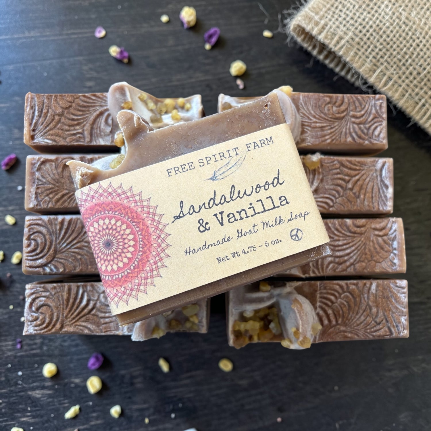 Handmade soap bars with a label on a dark surface