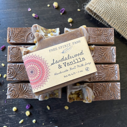Handmade soap bars with a label on a dark surface