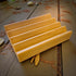 Wooden soap dish on a rustic wooden surface with leaves