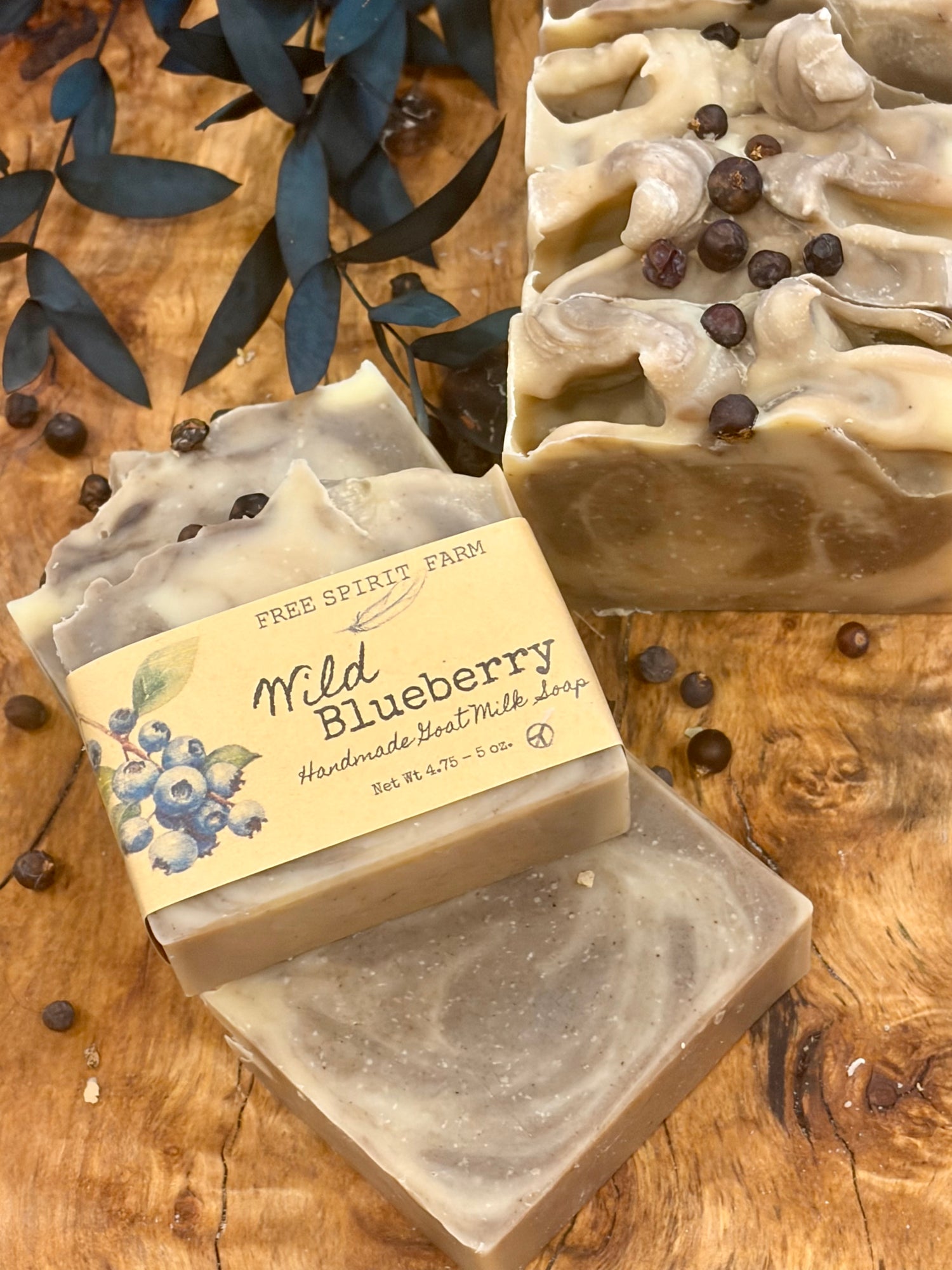 Three handmade soap bars from Free Spirit Farm, including a wrapped &